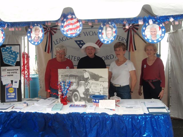 Elisa McCarthy, Pat George, Carole Mulready, and Mary Murray set up Faces of the League for Celebrate! West Hartford